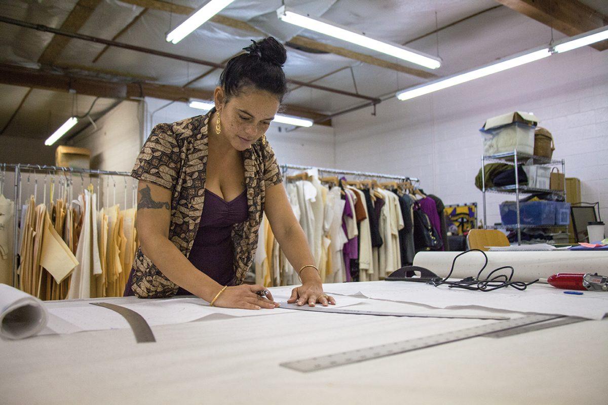 Mira Fannin, owner and designer of Sweet Skins Organic Apparel, sketches outline for men&#8217;s pants she will put in production for next season. Sweet Skins is a local organic apparel store located on 782 Blair Blvd, Eugene, OR. All clothes at Sweet Skins are designed by Fannin and handmade locally by women.