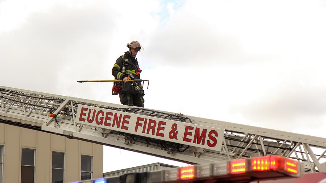 Firefighters work inside and outside of Taylor&#8217;s Bar and Grill after a fire broke out due to an electrical wire inside a wall in Eugene, Oregon on April 1, 2015. (Kenneth Osborn/Emerald)