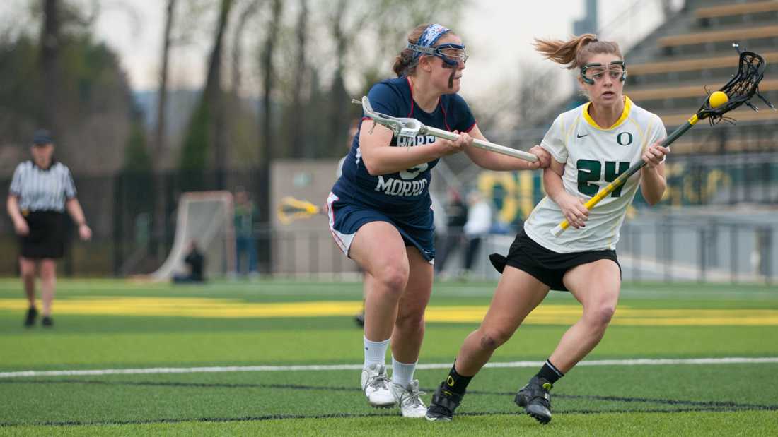 Oregon&#8217;s Rachel Steinberg (24) takes a push but keeps the ball secure. The Oregon Ducks defeat Robert Morris at Pape Field in Eugene, Oregon on Friday, March 13. (Cole Elsasser/Emerald)