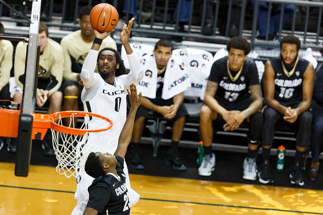 Oregon forward Dwayne Benjamin (0) shoots over Colorado guard Jaron Hopkins (23) during the first half. The Oregon Ducks play the Colorado Buffaloes at Matthew Knight Arena in Eugene, Oregon on February 18, 2015. (Ryan Kang/Emerald)