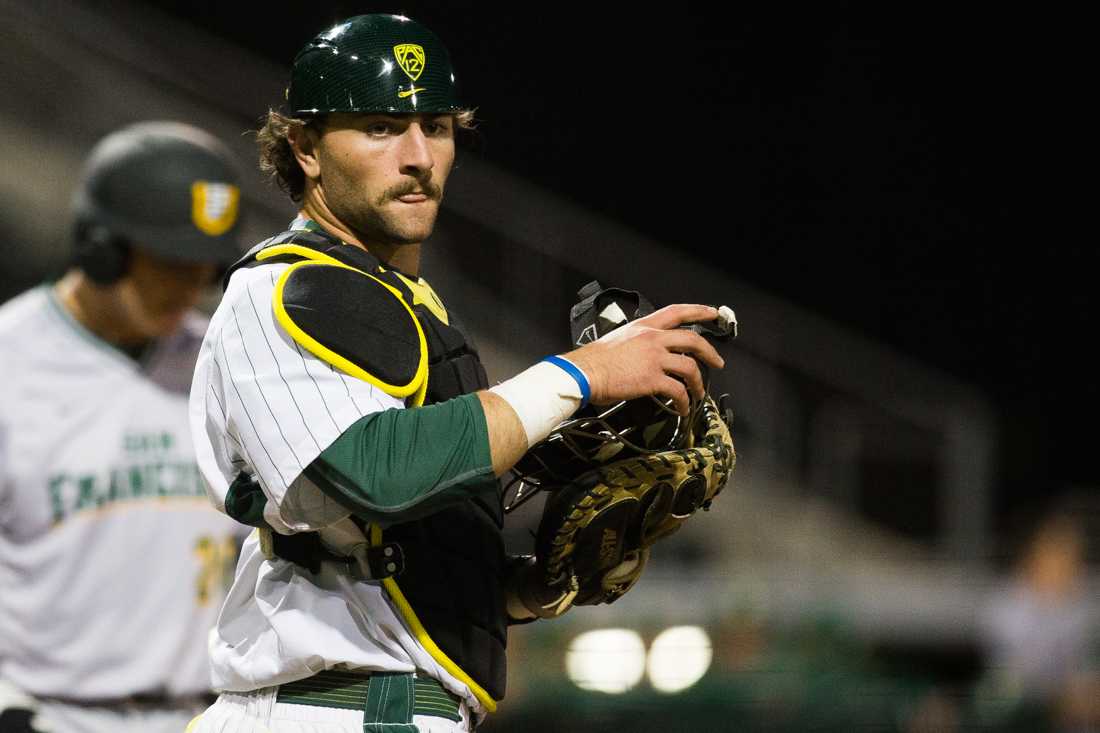 Oregon catcher Tim Susnara (6) communicates with coaches in the dugout during the top of the eighth inning. The Oregon Ducks play the San Francisco Dons at PK Park in Eugene, Oregon on Tuesday, March 10. (Taylor Wilder/Emerald)