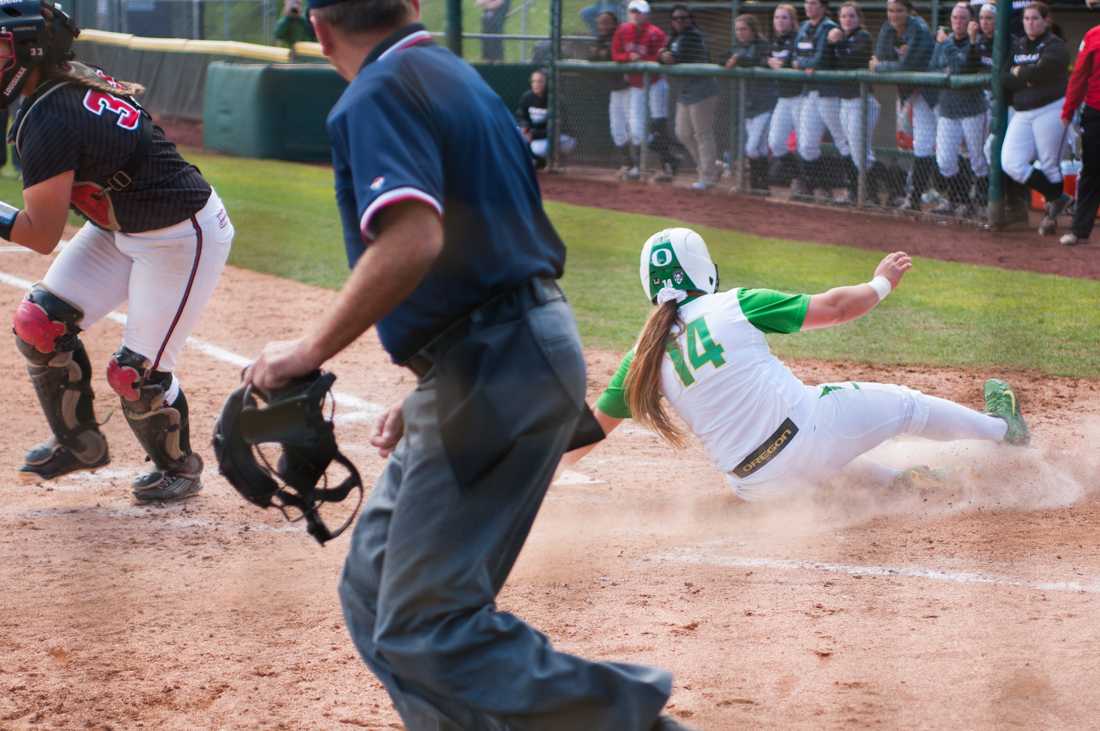 Oregon in fielder Hailey Decker (14) slides into home in the 4th inning. The Oregon Ducks play the Louisiana Ragin&#8217; Cajuns at Howe Field in Eugene, Oregon on April 25, 2015. (Cole Elsasser/Emerald)