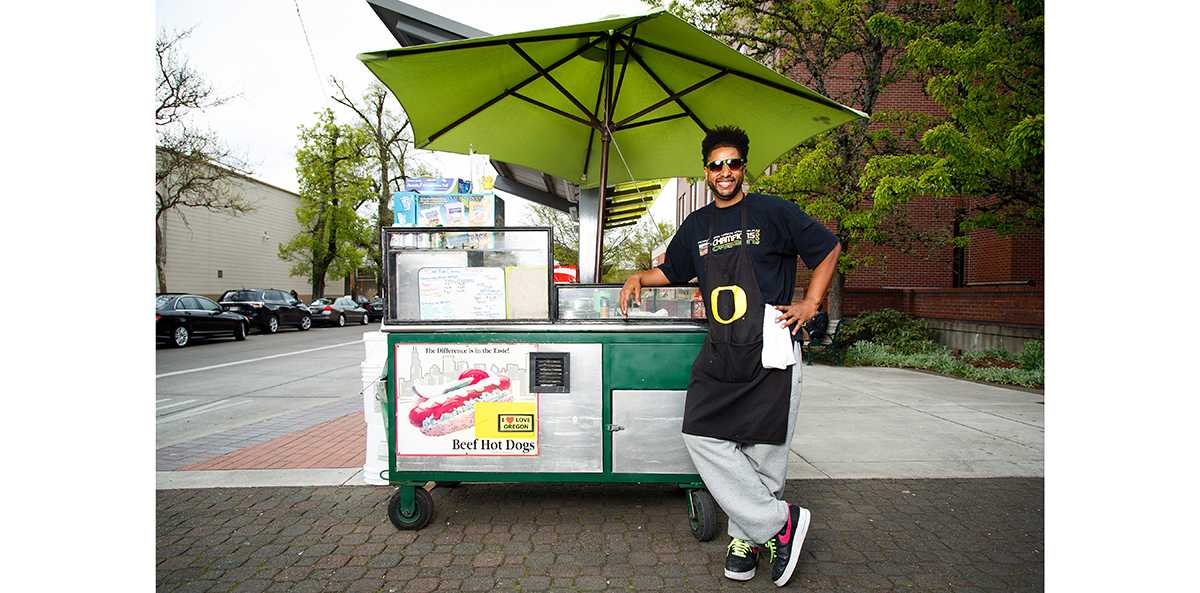 A girl steps up to the hotdog stand on the northeast corner of Kincaid Street and 13th Avenue, and asks if she can pay with a debit card. Robert James-Alexander Hamilton pulls out a hotdog and with a big smile explains that he doesn&#8217;t take cards, but she can just &#8230;