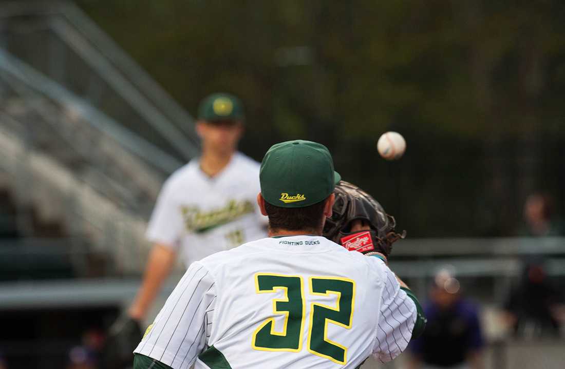 Oregon first baseman Brandon Cuddy (32) receives the ball from Oregon player Cole Irvin (19). The Oregon Ducks play the University of Washington Huskies at PK Park on Friday, April 24, 2015. (Eve Hess/Emerald).