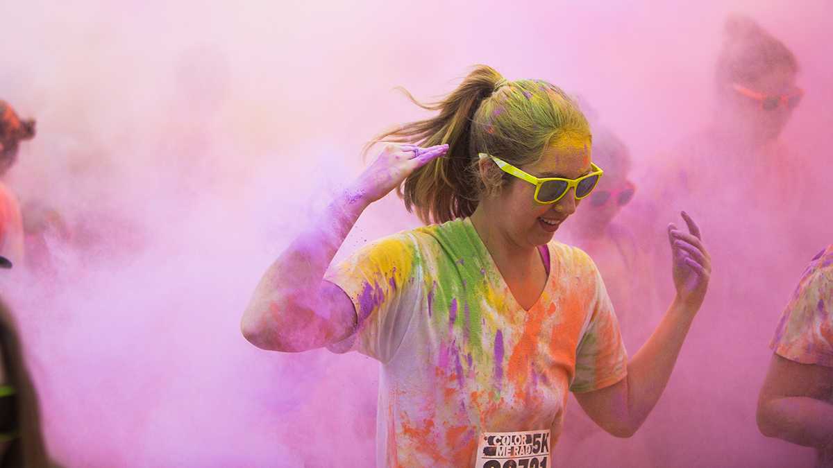 While runners run past the starting line, volunteers spew colored cornstarch through leaf blowers at them. Hundreds of residents around the Eugene area participated in the Color Me Rad 5K run near the Valley River Center on April 12, 2014. (Taylor Wilder/Emerald)