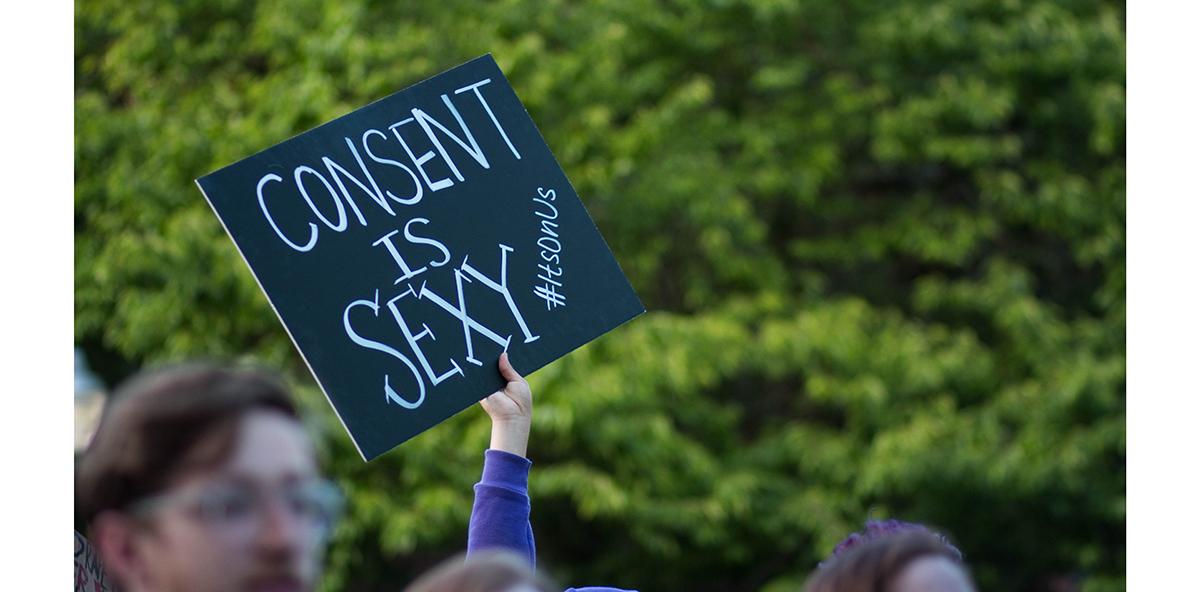 A sign made by one of the marchers is waved above the crowd during the march. The ASUO Women&#8217;s Center and Sexual Assault Support Services of Lane County presented Take Back the Night in Eugene, Ore. on Thursday, April 30, 2015. (Eve Hess/Emerald)