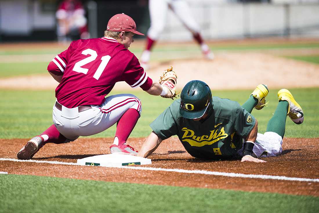 Oregon outfielder Scott Heineman (9) dives back to first base. The Oregon Ducks play the Stanford Cardinal at P.K. Park in Eugene, Oregon on May 3, 2015. (Natsumi Seki/Emerald)