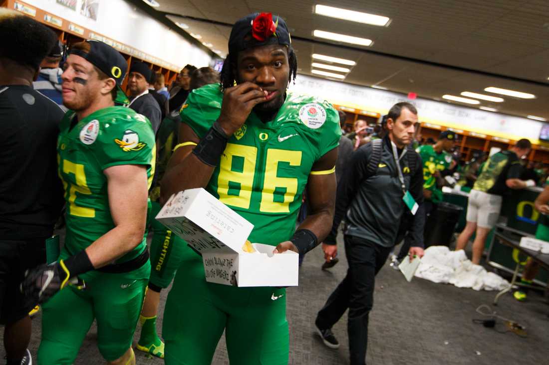 <p>Oregon linebacker Torrodney Prevot (86) chomps on a snack in the locker room after the game. The No. 2 Oregon Ducks play the No. 3 Florida State Seminoles at the Rose Bowl Stadium in Pasadena, California on January 1, 2015. (Ryan Kang/Emerald)</p>