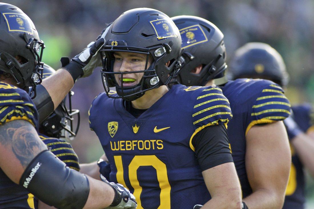 <p>Oregon Ducks quarterback Justin Herbert (10) celebrates with teammates after a touchdown in the first half. The Oregon Ducks host the No.5 Washington Huskies at Autzen Stadium in Eugene, Ore. on Oct.8, 2016. (Eric Cech/Emerald)</p>