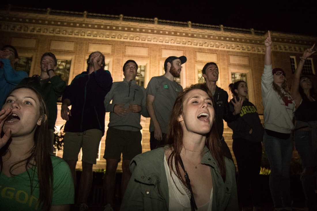 A group of students lead chants outside of the Knight Library. (Aaron Nelson/Emerald)