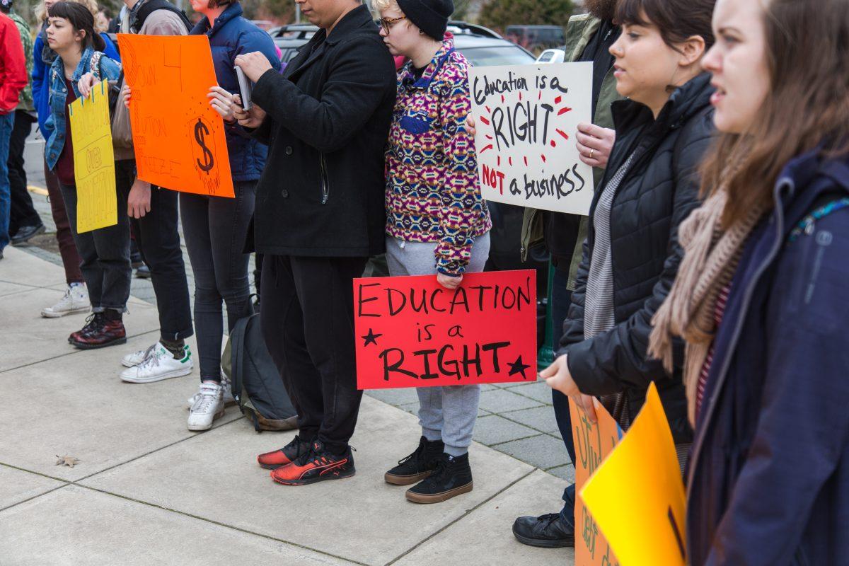 <p>Students and union members hold up their signs during the protest for the tuition increase. The UO Board of Trustees meeting for tuition increase meeting held at the Ford Alumni Center on Thursday, March 2nd, 2017. (Savannah Mendoza/Emerald)</p>