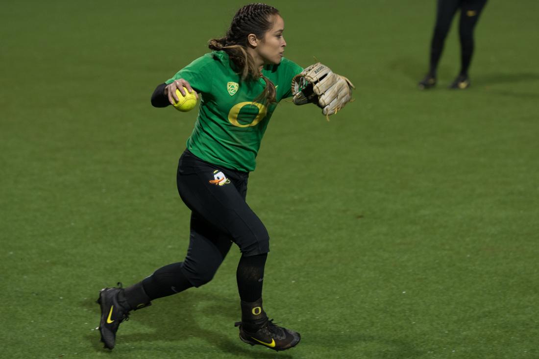 Quick to pick up the hit to outfield, Oregon left fielder Sammie Puentes (5) throws the ball in. The Oregon Ducks defeat the Pacific Tigers 8-0 at Jane Sanders Stadium on March 11, 2017. (Amanda Shigeoka/Emerald)