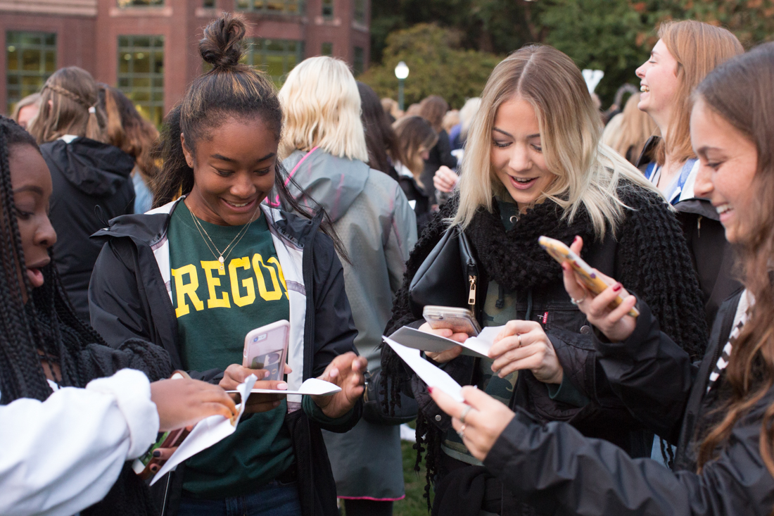 New members take Snapchats as they open their bids. Potential new members of University of Oregon&#8217;s sororities open their envelopes on Bid Day on the Knight Library lawn in Eugene, Ore., on Tuesday, Oct. 10, 2017. (Natalie Waitt-Gibson/Emerald)