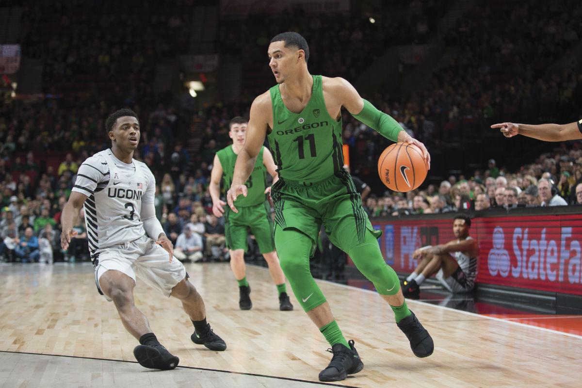 Keith Smith (11) attacks the rim in a game against UCONN in the PK80 tournament. (Adam Eberhart/Emerald)