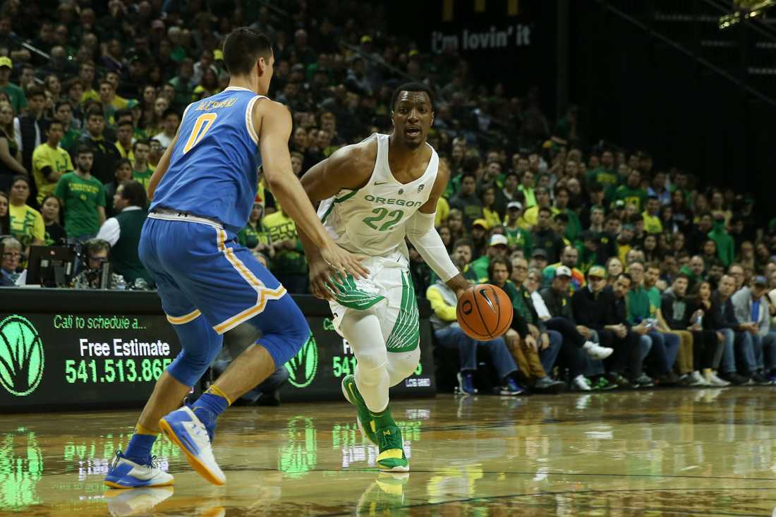 Oregon Ducks Forward Mikyle Mcintosh (13) drives past a UCLA defender. Oregon basketball plays the UCLA Bruins at Matthew Knight Arena in Eugene, Ore. on Jan. 20, 2018. (Natalie Waitt-Gibson/Emerald)