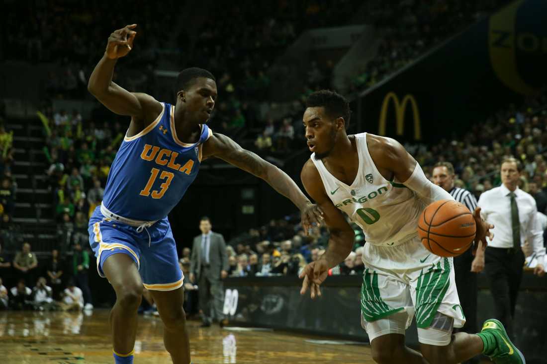 Ducks forward Troy Brown (0) dodges a UCLA Bruin. Oregon basketball plays the UCLA Bruins at Matthew Knight Arena in Eugene, Ore. on Jan. 20, 2018. (Natalie Waitt-Gibson/Emerald)