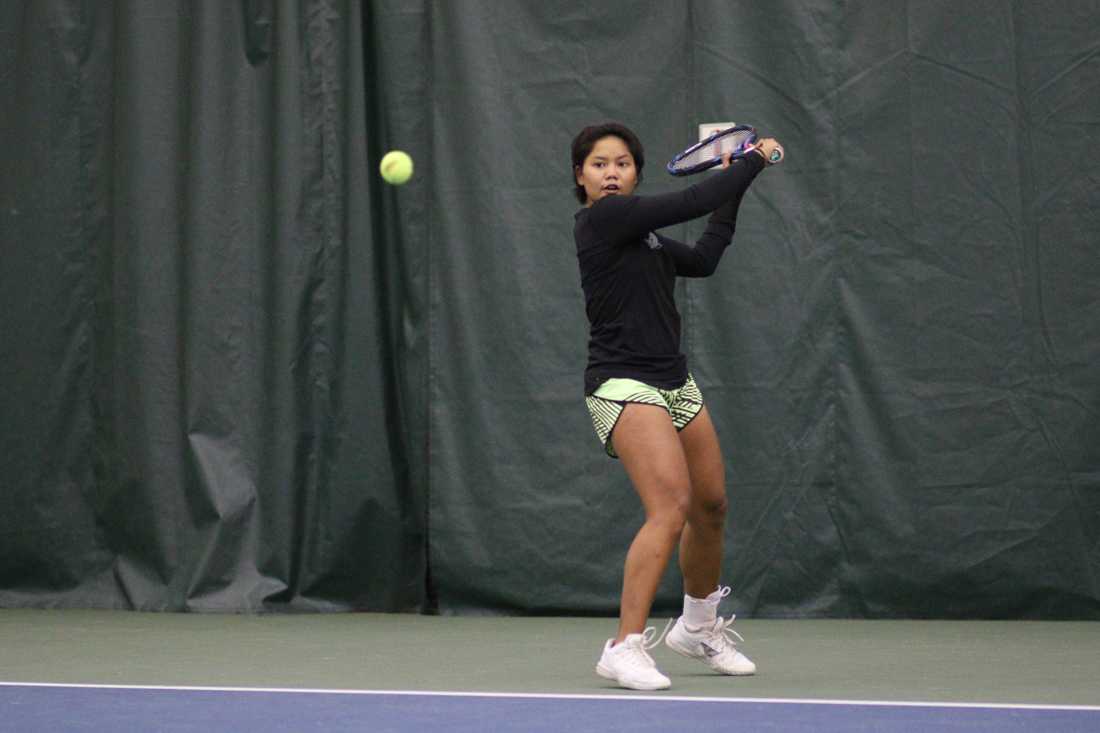 Oregon Ducks Rifanty Kahfiani swings for the return during her singles match. The Oregon Ducks face the Portland State Vikings at the Oregon Student Tennis Center in Eugene, Ore. on January 19, 2018. (Devin Roux/Emerald)