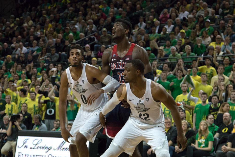 Ducks forwards MiKyle McIntosh (22) and Troy Brown (0) box out Arizona forward DeAndre Ayton (13). Oregon basketball take on the University of Arizona Wildcats at Matthew Knight Arena in Eugene, Ore. on Feb. 24, 2018. (Ben Green/Emerald)