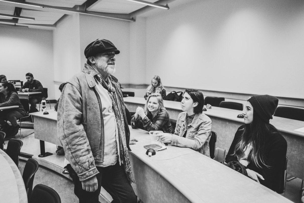 University of Oregon professor Tom Wheeler shares a moment with Music Industry Collective members Taylor Dalton (left), Elissa Carlson and Cassey Tollett on Oct. 12, 2017 in the Lillis Complex at the University of Oregon. (Phillip Quinn / Emerald)