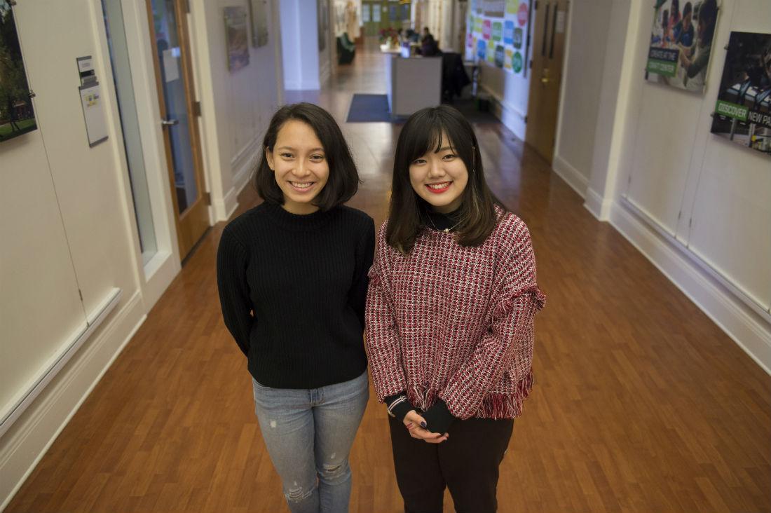 Conversation partners Ellie Yeo and Tomoka Uechi in Agate Hall. (Adam Eberhardt/Daily Emerald)