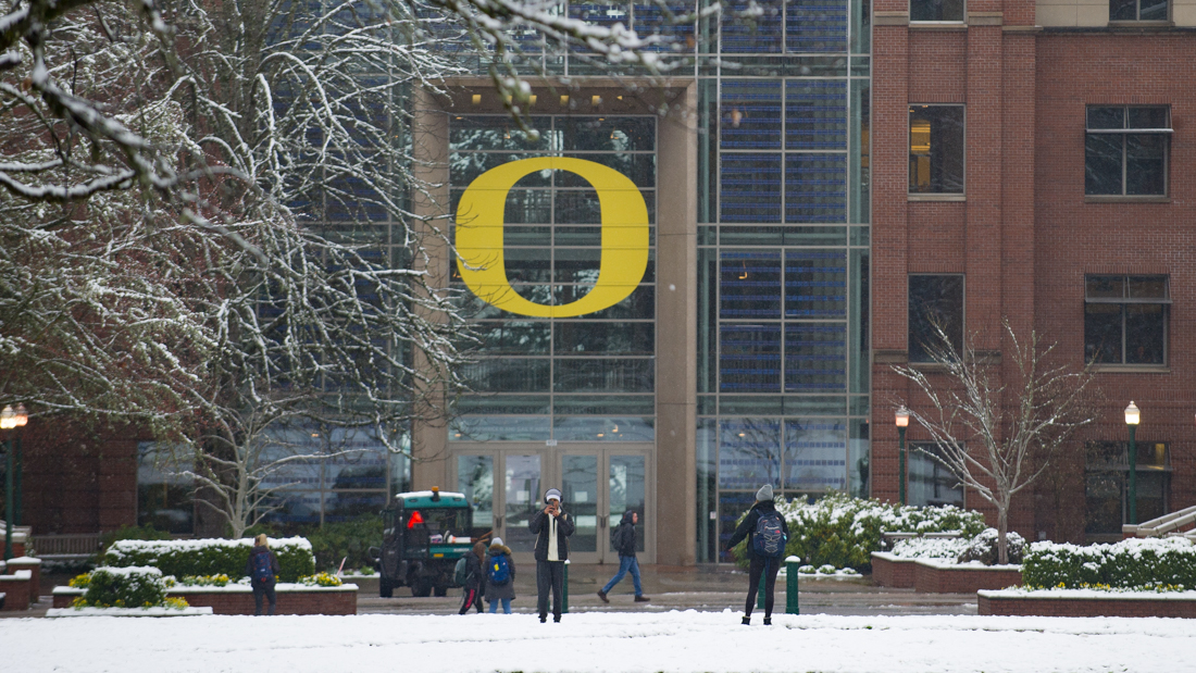 Students take pictures of the snow on the lawn in front of the Lillis Complex after a period of snowfall in Eugene, Ore. on Thursday, Feb. 22, 2018. (Adam Eberhardt/Emerald)