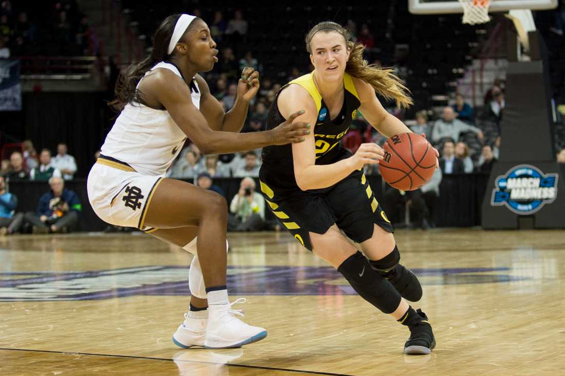 Oregon Ducks guard Sabrina Ionescu (20) is fouled by a Notre Dame player while dribbling down the court. The Oregon Ducks play Notre Dame in the Elite Eight round of the NCAA tournament at the Spokane Veterans Memorial Arena in Spokane, Wash. on Monday, March 26, 2018. (Adam Eberhardt/Emerald)