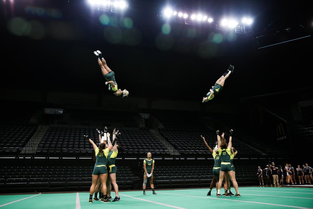 The Ducks synchronize stunts. Oregon acrobatics and tumbling falls to Quinnipac in tri-meet on Mar. 11, 2018. (Natalie Waitt-Gibson/Emerald)