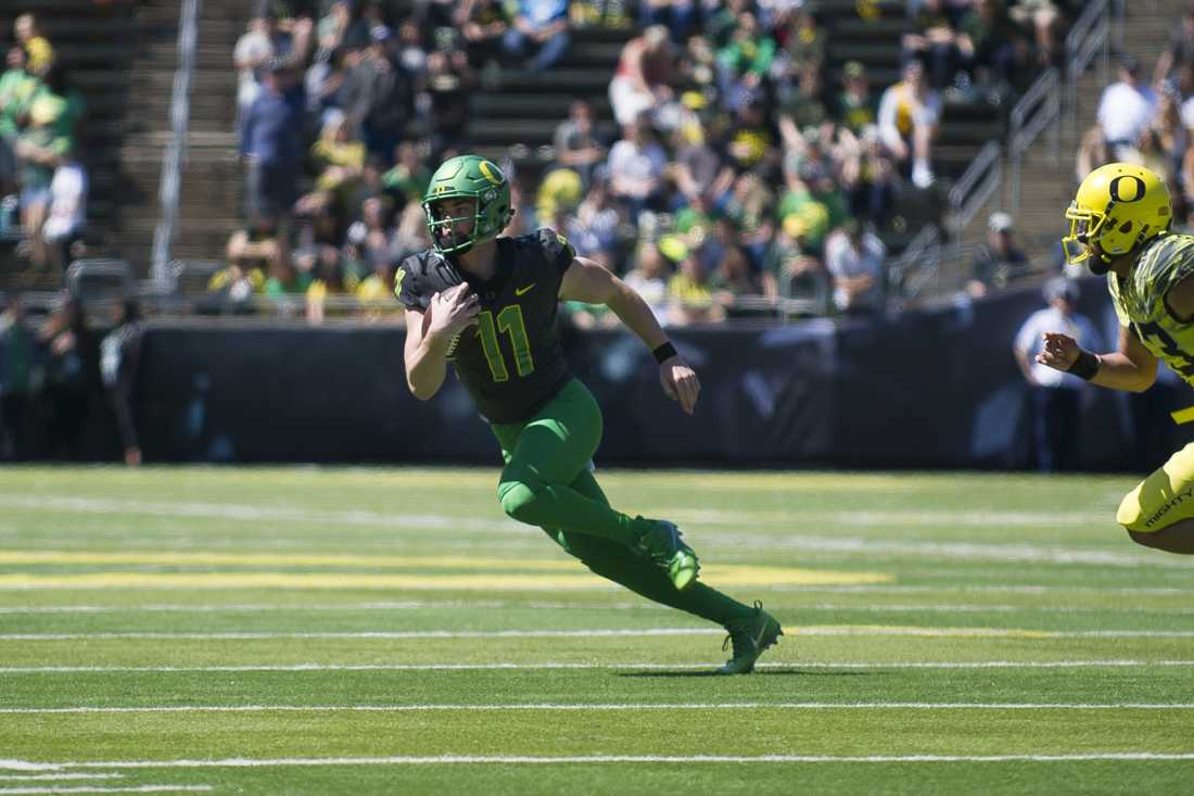 Team Thunder quarterback Braxton Burmeister (11) scrambles during a play. Team Thunder plays Team Lightning at the Oregon spring football game at Autzen Stadium in Eugene, Ore. on Saturday, April 21, 2018. (Adam Eberhardt/Emerald)