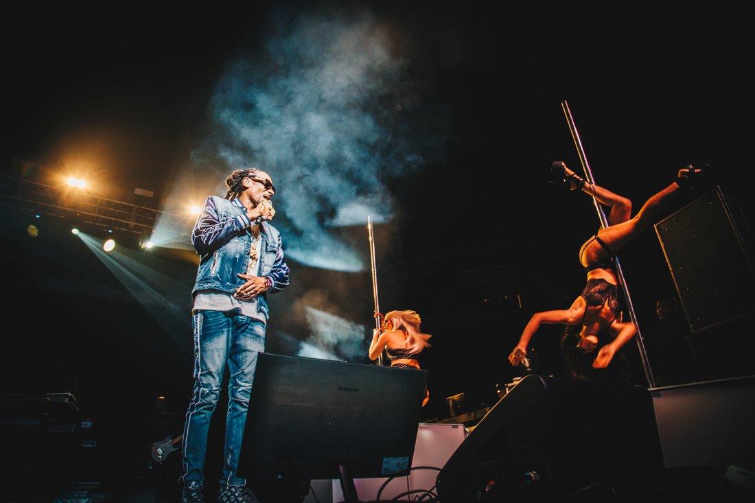 Snoop Dogg is joined on stage by his pole-dancing backup dancers. Snoop Dogg and Wiz Khalifa bring the 420 Wellness Retreat Tour to Matthew Knight Arena in Eugene, Ore. on April 21, 2018. (Sarah Northrop/Emerald)