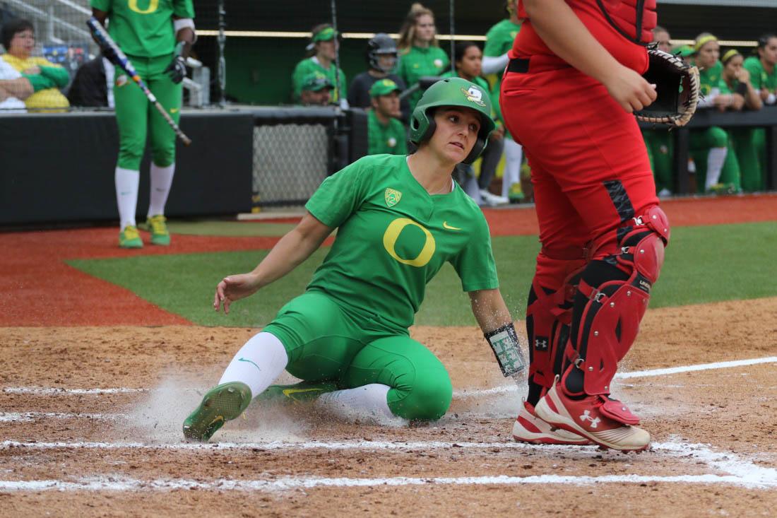 Oregon Ducks infielder Lauren Lindvall (8) slides into home plate. The Oregon Ducks play the Utah Swoops at Jane Sanders Stadium in Eugene, Ore. on Sunday May 6, 2018. (Devin Roux/Emerald)