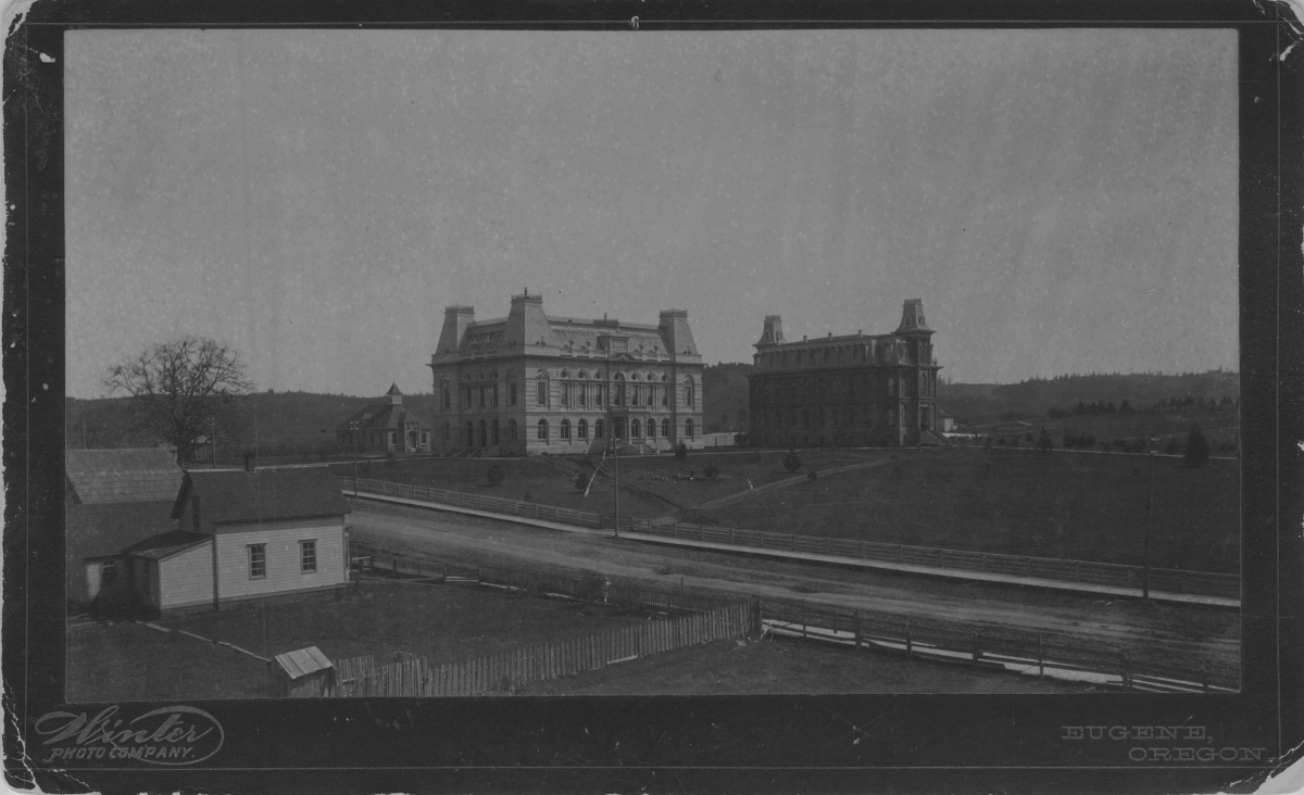 Looking across 11th Avenue circa 1895, the old campus oak tree (far left) featured prominently in the early days of UO alongside Villard Hall (center) and Deady Hall (center-right). (Courtesy of Special Collections and University Archives)