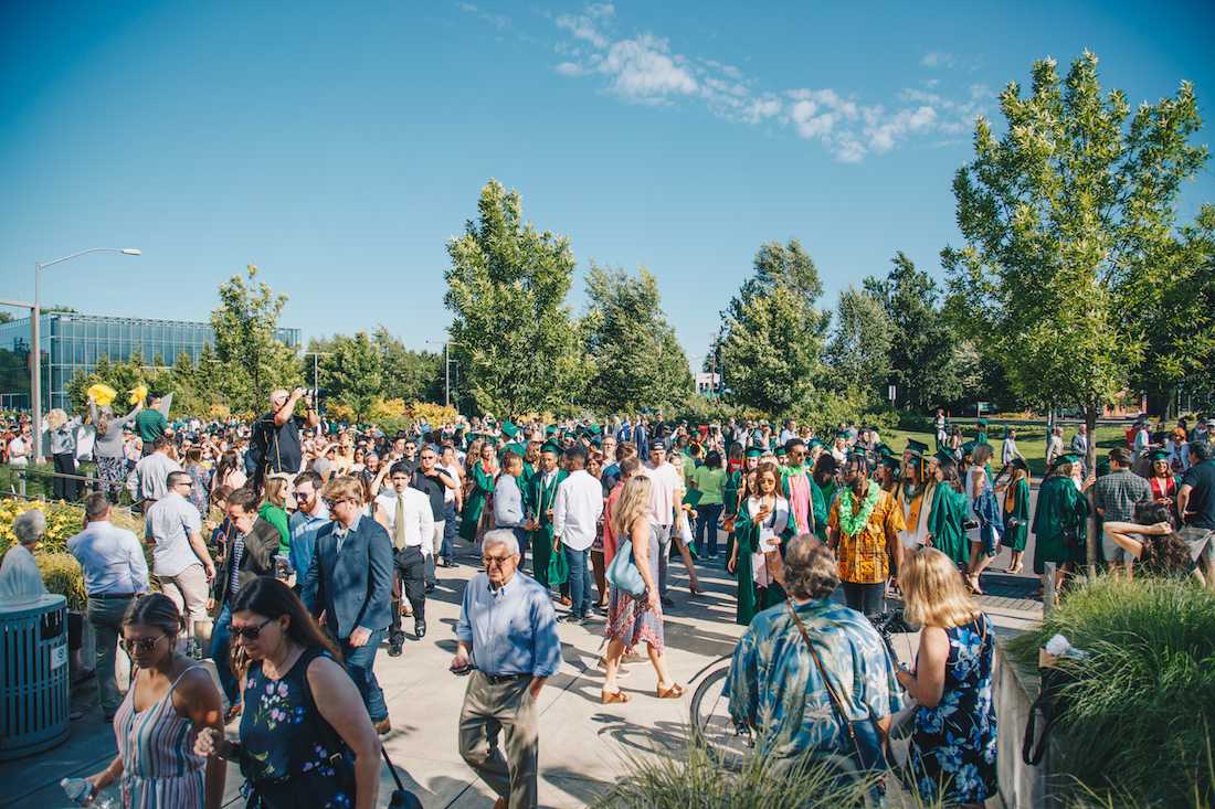 Graduates and their families walk into Matthew Knight Arena for the commencement ceremony. The University of Oregon celebrates its 142nd commencement with the traditional Thirteenth Avenue Duck Grad Parade on June 18, 2018. (Sarah Northrop/Emerald)