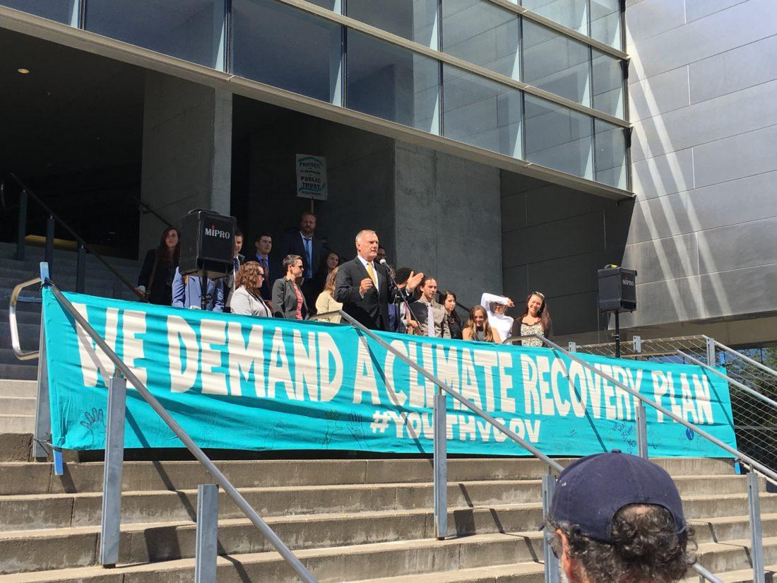 Phil Gregory, an attorney for the plaintiffs, addresses demonstrators and the media at a press conference outside of the Wayne L. Morse Courthouse on Wednesday, July 18, 2018. (Michael Tobin/Emerald)