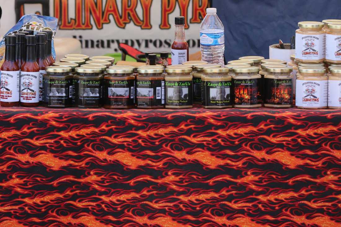 Booths full of jars of hot sauce. The OMSI Bridge Lot hosts the PDX Hot Sauce Expo in Portland, Ore. on August 5, 2018. (Devin Roux/Emerald)