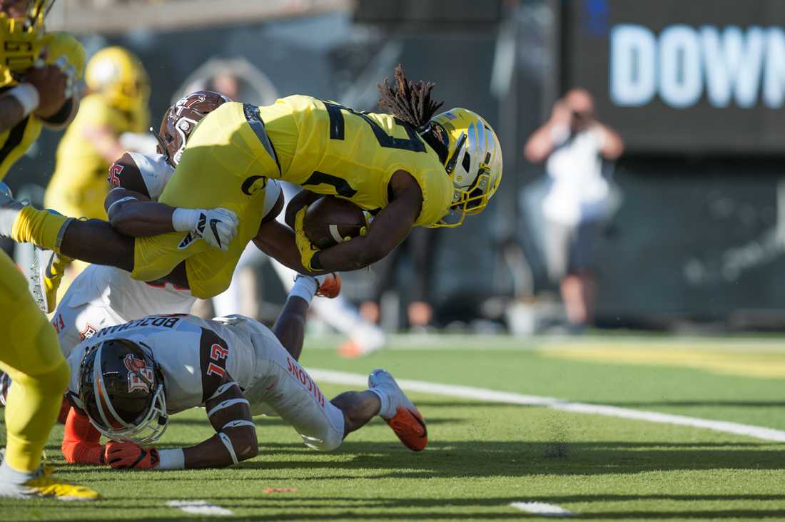 A Falcon tackles Oregon Ducks runningback Darrian Felix (22). Oregon Ducks Football hosts Bowling Green in home opener at Autzen Stadium in Eugene, Ore. on Saturday, September 1, 2018. (Devin Roux/Emerald)