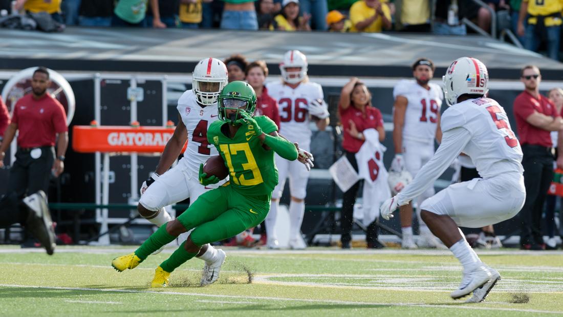 Ducks wide reciever Dillon Mitchell (13) attempts to run past the defenders. Oregon Ducks Football takes on Stanford at Autzen Stadium on Sept. 22, 2018. (Ben Green/Emerald)