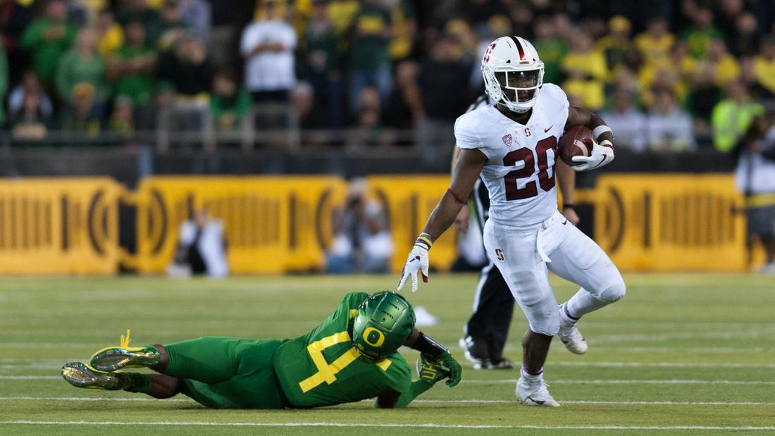 Stanford running back Bryce Love (20) pushes Oregon cornerback Thomas Graham Jr. (4) to the ground. Oregon Ducks Football takes on Stanford at Autzen Stadium on Sept. 22, 2018. (Ben Green/Emerald)