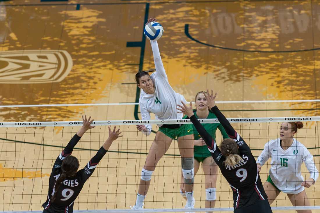 Ducks right side hitter Willow Johnson (4) kills the ball. Oregon Ducks women's volleyball takes on New Mexico State at Matthew Knight Arena in Eugene, Ore. on Nov. 29, 2018. (Ben Green/Emerald)