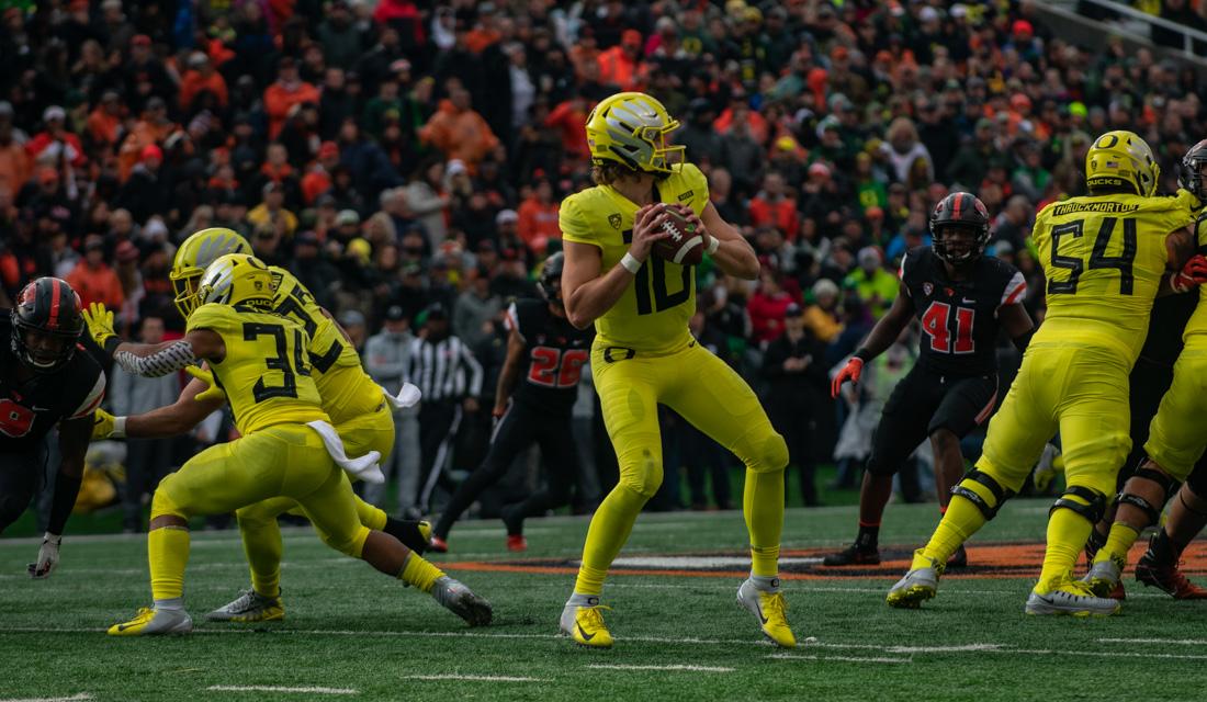 Oregon Ducks quarterback Justin Herbert looks down the field for the open man. Oregon Ducks football takes on the Oregon State University Beavers for the Civil War at Reser Stadium in Corvallis, Ore. on Nov. 23, 2018. (Henry Ward/Emerald)