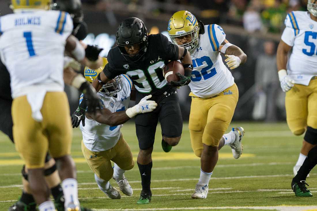 Ducks wide reciever Jaylon Redd (30) breaks through the Bruins defense. Oregon Ducks Football takes on UCLA at Autzen Stadium in Eugene Ore. on Nov. 3, 2018. (Ben Green/Emerald)