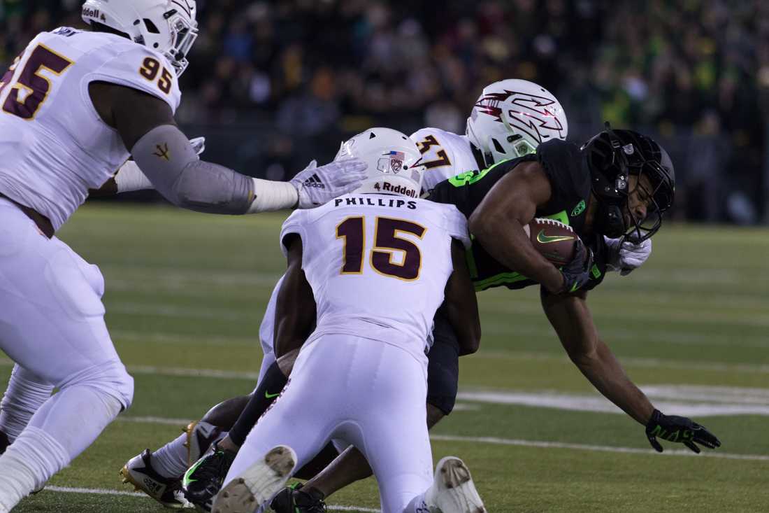 Ducks running back Tony Brooks-James (20) is brought to the ground. Oregon Ducks football takes on Arizona State at Autzen Stadium in Eugene Ore. on Nov. 17, 2018. (Ben Green/Emerald)