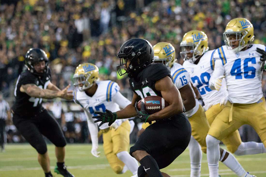 Oregon Ducks running back Tony Brooks-James (20) dodges opponents. Oregon Ducks Football takes on UCLA at Autzen Stadium in Eugene Ore. on Nov. 3, 2018. (Maddie Knight/Emerald)