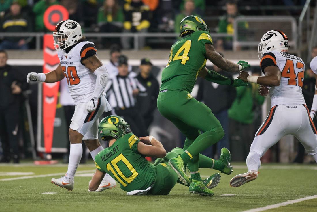 Oregon quarterback Justin Herbert (10) slides for the first down. The Oregon Ducks host the Oregon State Beavers for the 121st Civil War at Autzen Staidum in Eugene, Ore. on Saturday, Nov. 25, 2017. (Phillip Quinn/Emerald)