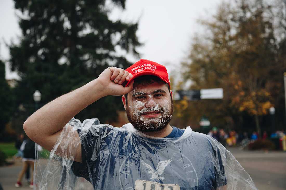 Sophomore Alec Sapolin walks around the intersection of Thirteenth Avenue and University Street to gather the attention of passersby.&#160;UO College Republicans holds a "Pie-a-republican" fundraiser on campus on Nov. 15, 2018. (Sarah Northrop/Emerald)