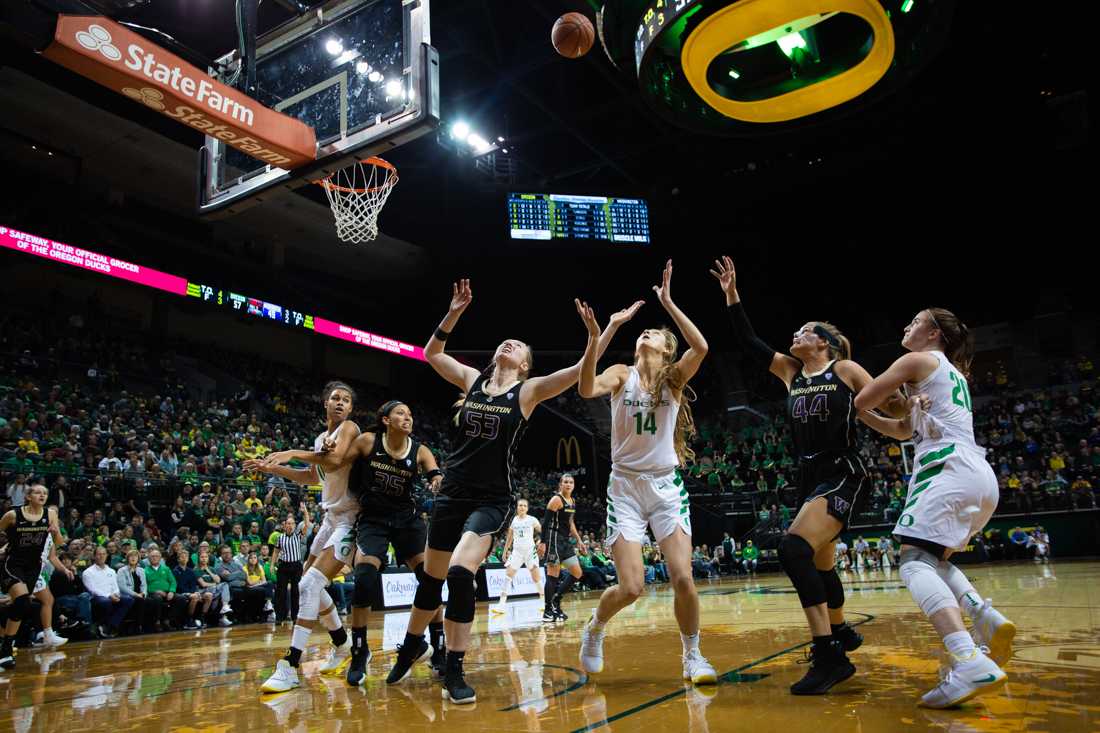 The Ducks and Huskies rush for possession of the ball. Oregon Ducks women's basketball takes on University of Washington at Matthew Knight Arena in Eugene, Ore. on Jan. 4, 2019. (Sarah Northrop/Emerald)