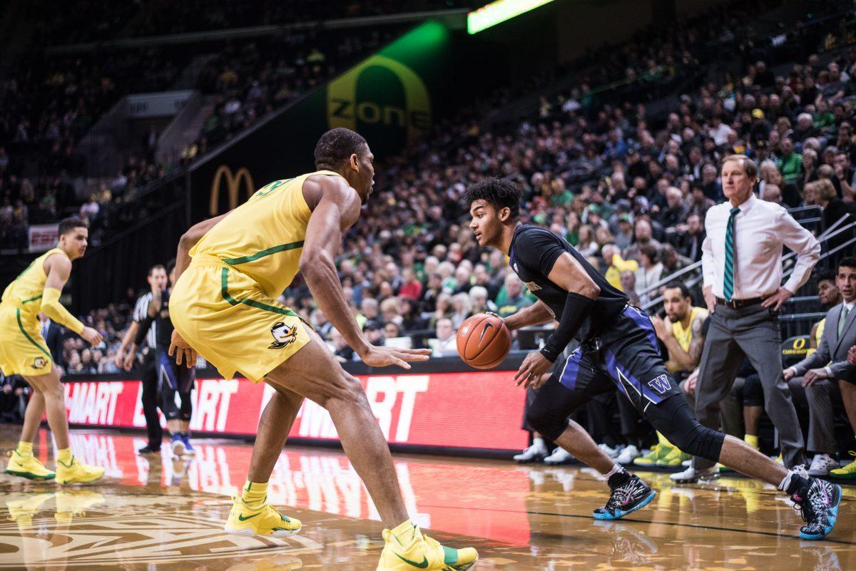 Huskies guard Jamal Bey (0) dribbles the ball around Ducks forward Francis Okoro (33). Oregon Ducks men&#8217;s basketball takes on University of Washington at Matthew Knight Arena in Eugene, Ore. on Jan. 24, 2019. (Marissa Willke/Emerald)