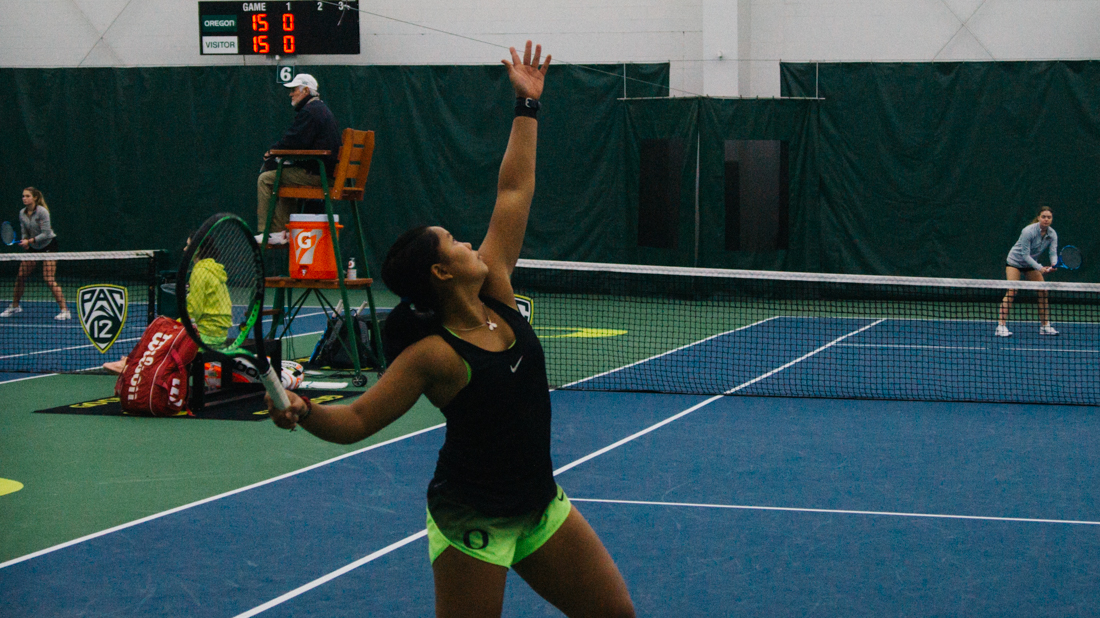 Rifanty Kahfiani serves for the Ducks in a doubles match. Oregon Ducks women's tennis takes on University of Montana at the Student Tennis Center in Eugene, Ore. on Feb. 15, 2019. (Connor Cox/Emerald)