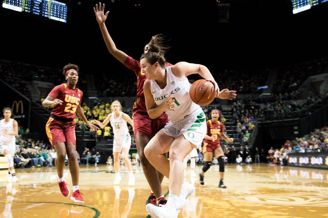 Erin Boley, forward for the Ducks, goes up against the Trojans to shoot. Oregon Ducks women&#8217;s basketball defeat USC Trojans 96 to 78 while saying goodbye to seniors at Matthew Knight Arena in Eugene, Ore. Feb. 24, 2019. (Madi Mather/Emerald)