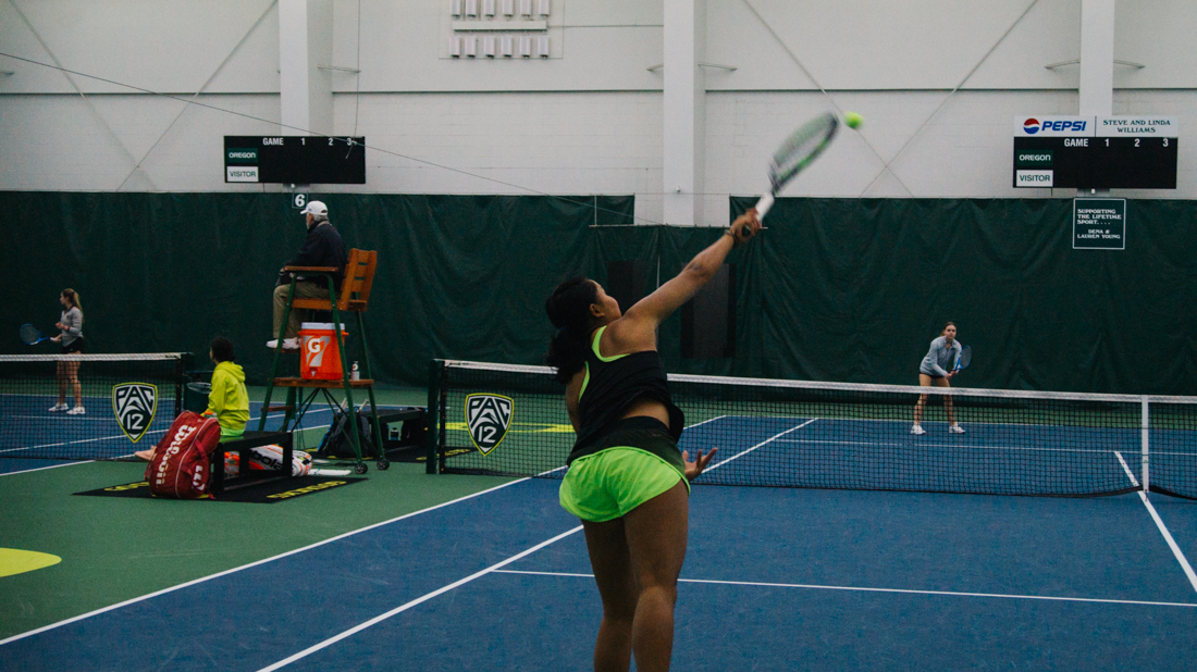 Rifanty Kahfiani volleys for the Ducks in a doubles match. Oregon Ducks women's tennis takes on University of Montana at the Student Tennis Center in Eugene, Ore. on Feb. 15, 2019. (Connor Cox/Emerald)