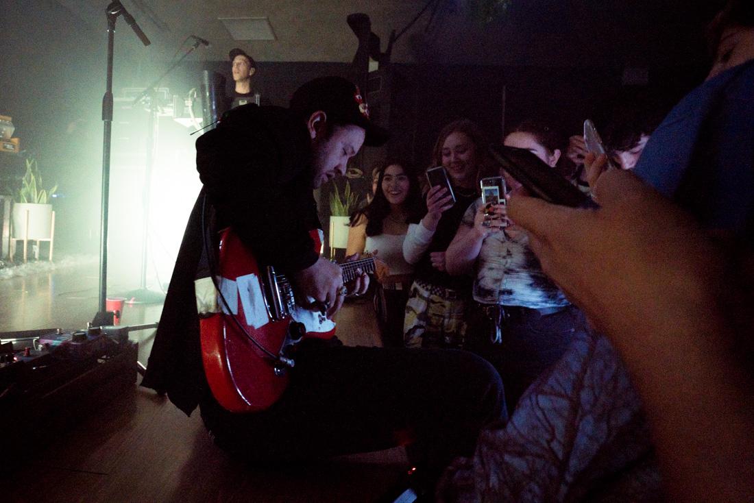 Leader singer and guitarist Ruban Nielson sits at the edge of the stage after diving into the crowd. Portland-based, New Zealand band Unknown Mortal Orchestra begins Sex and Food album tour at WOW Hall April 11, 2018. (Dana Sparks/Emerald)